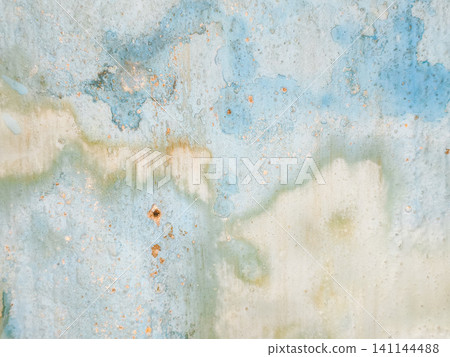Abstract background of a weathered and distressed wall with peeling paint and plaster in faded light blue and beige tones, showcasing aged texture and grunge details. Abstract background of a weathered and distressed wall with peeling paint and plaster in faded light blue and beige tones, showcasing aged texture and grunge details. 141144488