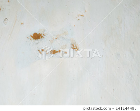 Abstract background of a weathered and distressed wall with peeling paint and plaster in faded light blue and beige tones, showcasing aged texture and grunge details. Abstract background of a weathered and distressed wall with peeling paint and plaster in faded light blue and beige tones, showcasing aged texture and grunge details. 141144493