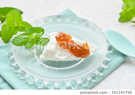 A dessert with whipped cream and homemade rhubarb jam. 141145798