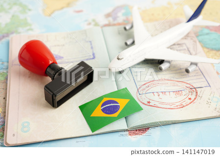 Brazil flag and passport with airplane for travel. Brazil flag and passport with airplane for travel. 141147019