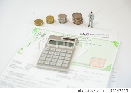 iDeCo stamps and calculator, miniature figures standing next to piles of money, an image of asset building, retirement funds. iDeCo stamps and calculator, miniature figures standing next to piles of money, an image of asset building, retirement funds. 141147335