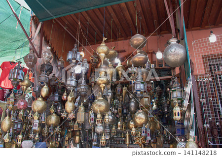 Display of handcrafted metal lanterns and lamps in a traditional souk in Marrakech, Morocco 141148218
