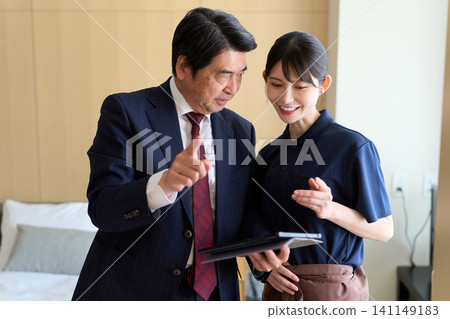 Businessmen who manage the quality control of hotel room cleaning. Businessmen who manage the quality control of hotel room cleaning. 141149183