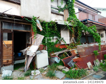 A deserted house overgrown with plants and on the verge of collapse A deserted house overgrown with plants and on the verge of collapse 141149470