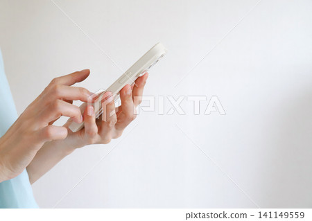 Hands for operating a smartphone Hands for operating a smartphone 141149559