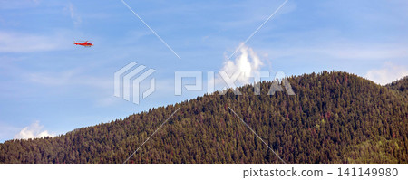 red medical emergency helicopter flying over green mountains, banner red medical emergency helicopter flying over green mountains, banner 141149980