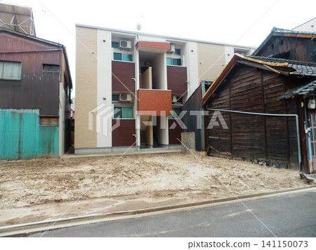 A rectangular vacant lot surrounded by buildings A rectangular vacant lot surrounded by buildings 141150073