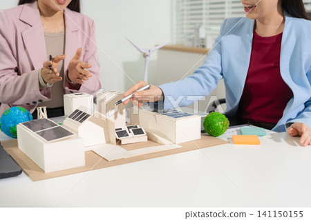 Engineer Teamwork Meeting, with partner on model building at company office working technology, Renewable energy-based green businesses and global warming. Engineer Teamwork Meeting, with partner on model building at company office working technology, Renewable energy-based green businesses and global warming. 141150155