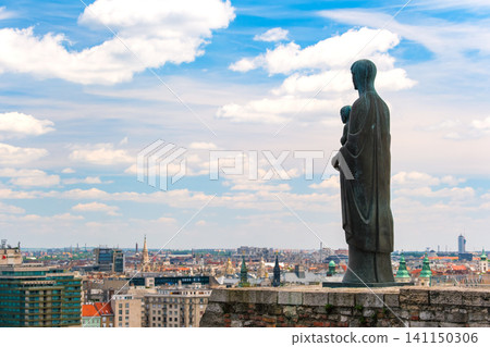 A view of the back of a statue of the Virgin Mary overlooking the vast cityscape from the Royal Palace Hill in Budapest, Hungary. 141150306