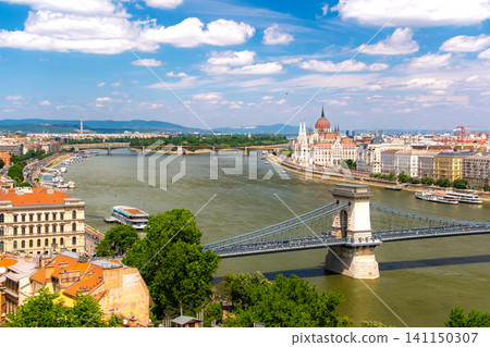 A stunning panoramic view of the Danube River and Budapest from the Royal Castle Hill in Budapest, Hungary. A stunning panoramic view of the Danube River and Budapest from the Royal Castle Hill in Budapest, Hungary. 141150307