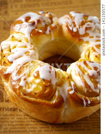 Apple ring bread with icing decoration and English lettering background. Apple ring bread with icing decoration and English lettering background. 141150577