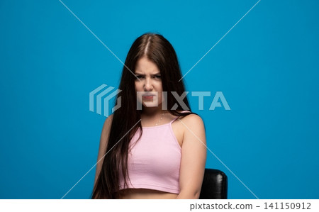 Young woman expressing anger and frustration, frowning intensely with a displeased facial expression, feeling annoyed Young woman expressing anger and frustration, frowning intensely with a displeased facial expression, feeling annoyed 141150912