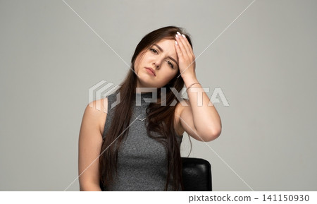 Young woman experiencing severe headache or migraine, feeling stressed, tired, and unhealthy, coping with pain and exhaustion Young woman experiencing severe headache or migraine, feeling stressed, tired, and unhealthy, coping with pain and exhaustion 141150930