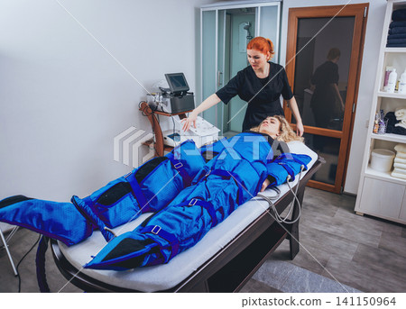 Pressotherapy machine on woman in beauty center Pressotherapy machine on woman in beauty center 141150964