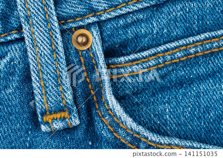 Macro detail of blue jeans with pocket, rivet and stitching Macro detail of blue jeans with pocket, rivet and stitching 141151035