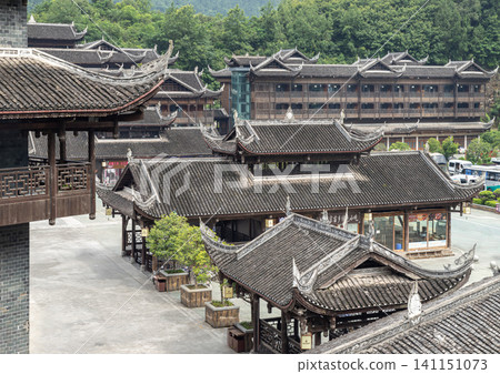 Elevated view of the traditional wooden pavilions and layered tile roofs at Chiyou Jiuli City cultural complex in Chongqing, China. This image beautifully illustrates classic Chinese vernacular Elevated view of the traditional wooden pavilions and layered tile roofs at Chiyou Jiuli City cultural complex in Chongqing, China. This image beautifully illustrates classic Chinese vernacular 141151073