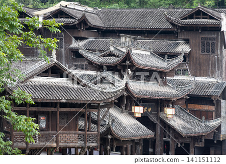 Intricate vernacular timber architecture showcasing the complex interlocking frames and hanging pavilions (Diaojiaolou) typical of the Miao ethnic minority culture. Intricate vernacular timber architecture showcasing the complex interlocking frames and hanging pavilions (Diaojiaolou) typical of the Miao ethnic minority culture. 141151112