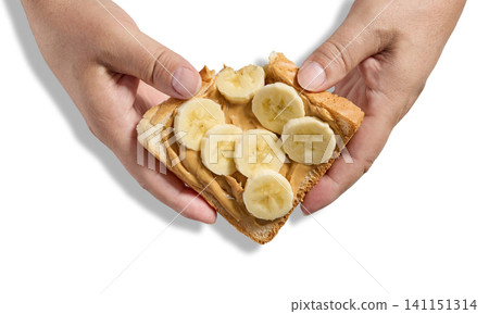 toast slice with peanut butter and banana in human hands toast slice with peanut butter and banana in human hands 141151314