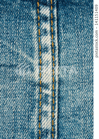 Blue denim fabric texture with orange seam and stitching Blue denim fabric texture with orange seam and stitching 141151409