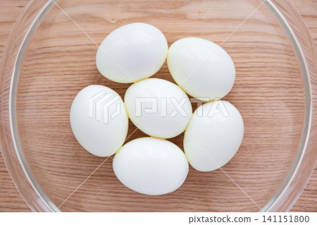Peeled hard-boiled eggs in a glass bowl Peeled hard-boiled eggs in a glass bowl 141151800