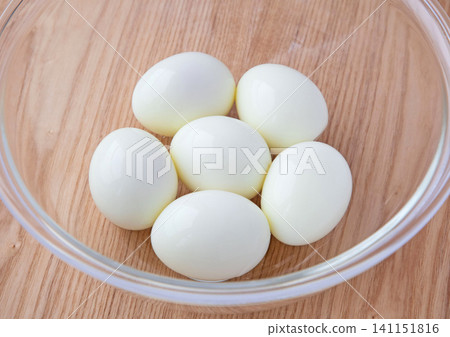 Peeled hard-boiled eggs in a glass bowl Peeled hard-boiled eggs in a glass bowl 141151816