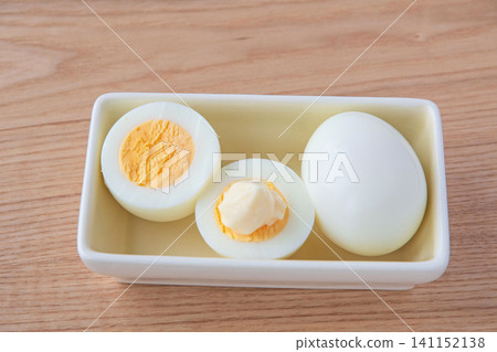 Hard-boiled eggs cut in half and placed in a bowl Hard-boiled eggs cut in half and placed in a bowl 141152138