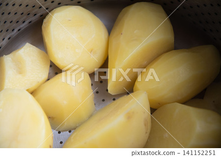 Potatoes steamed in a pot Potatoes steamed in a pot 141152251