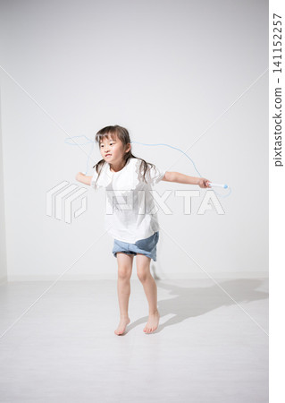 A Japanese girl enjoys jump rope; fostering athletic ability and physical fitness in children; an image of sports in the world. A Japanese girl enjoys jump rope; fostering athletic ability and physical fitness in children; an image of sports in the world. 141152257