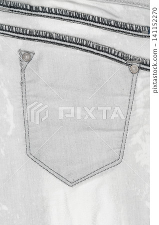 Closeup of white denim jeans pocket with stitching and metal rivets Closeup of white denim jeans pocket with stitching and metal rivets 141152270