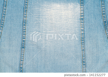 Light blue denim fabric texture with vertical seams Light blue denim fabric texture with vertical seams 141152277