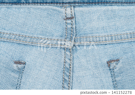 Closeup of light blue denim jeans with detailed stitching and texture Closeup of light blue denim jeans with detailed stitching and texture 141152278