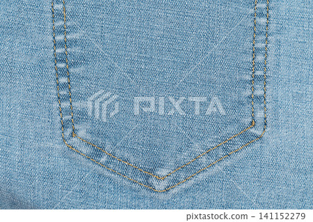Closeup of denim pocket with yellow stitching on light blue jeans fabric Closeup of denim pocket with yellow stitching on light blue jeans fabric 141152279