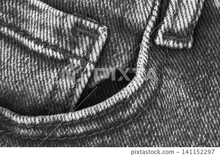 Denim fabric texture with pocket detail in monochrome flat lay Denim fabric texture with pocket detail in monochrome flat lay 141152297