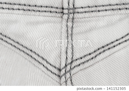 Denim fabric texture with gray stitching pattern top view Denim fabric texture with gray stitching pattern top view 141152305