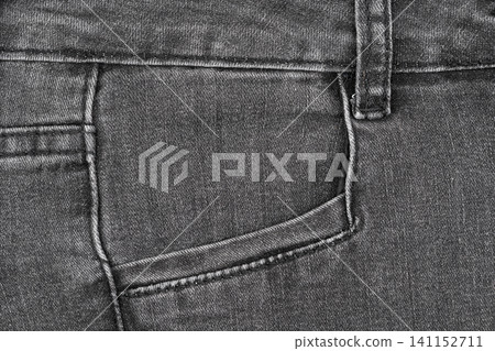 Black denim jeans fabric texture with front pocket and seam detail Black denim jeans fabric texture with front pocket and seam detail 141152711