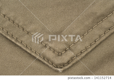 Closeup of olive green fabric with diagonal stitching detail Closeup of olive green fabric with diagonal stitching detail 141152714