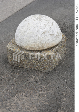 Concrete parking bollard barrier on asphalt pavement side view 141152869