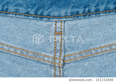 Close up of blue denim jeans with golden stitching detail 141152889