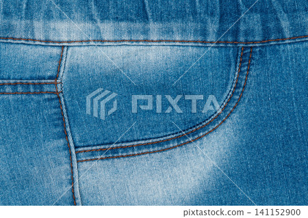 Blue denim jeans front pocket detail with brown stitching and faded texture Blue denim jeans front pocket detail with brown stitching and faded texture 141152900