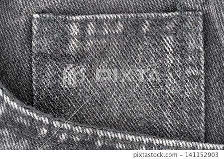 Denim fabric texture with coin pocket detail in top view Denim fabric texture with coin pocket detail in top view 141152903