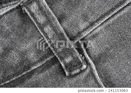 Denim texture closeup top view of belt loop with stitching details and fabric weave Denim texture closeup top view of belt loop with stitching details and fabric weave 141153063