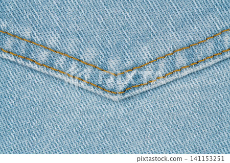 Close up view of blue denim jeans pocket with orange thread stitching. Detail of durable fabric texture for fashion garment design. Classic textile material pattern for casual apparel Close up view of blue denim jeans pocket with orange thread stitching. Detail of durable fabric texture for fashion garment design. Classic textile material pattern for casual apparel 141153251
