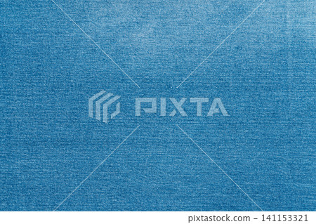 Blue denim fabric texture background. Closeup of classic jeans textile material Blue denim fabric texture background. Closeup of classic jeans textile material 141153321