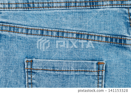Blue denim jeans texture with back pocket and orange stitching Blue denim jeans texture with back pocket and orange stitching 141153328