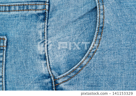 Blue denim jeans front pocket texture with orange stitching Blue denim jeans front pocket texture with orange stitching 141153329