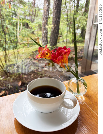 Coffee and red flowers in a glass vase Coffee and red flowers in a glass vase 141153599