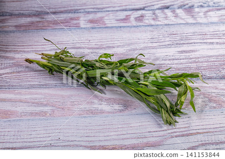 Fresh green tarragon bunch on rustic wooden table background Fresh green tarragon bunch on rustic wooden table background 141153844