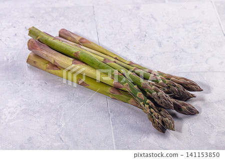 Fresh green asparagus spears on light textured background Fresh green asparagus spears on light textured background 141153850