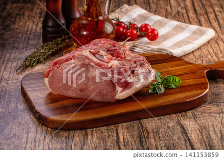 Fresh raw pork meat with spices and vegetables on rustic wooden table Fresh raw pork meat with spices and vegetables on rustic wooden table 141153859