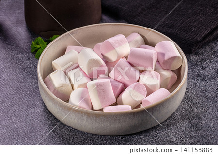 Pink white marshmallows in ceramic bowl. Soft sweet candy dessert snack Pink white marshmallows in ceramic bowl. Soft sweet candy dessert snack 141153883